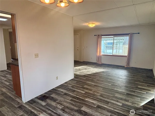 a view of a room with wooden floor and a window