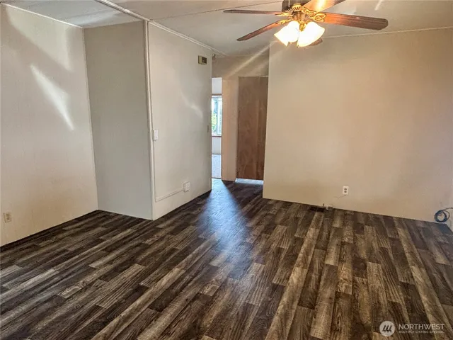 a view of a room with wooden floor