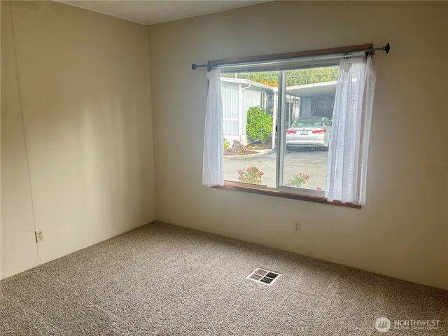 an empty room with closet and a bathroom