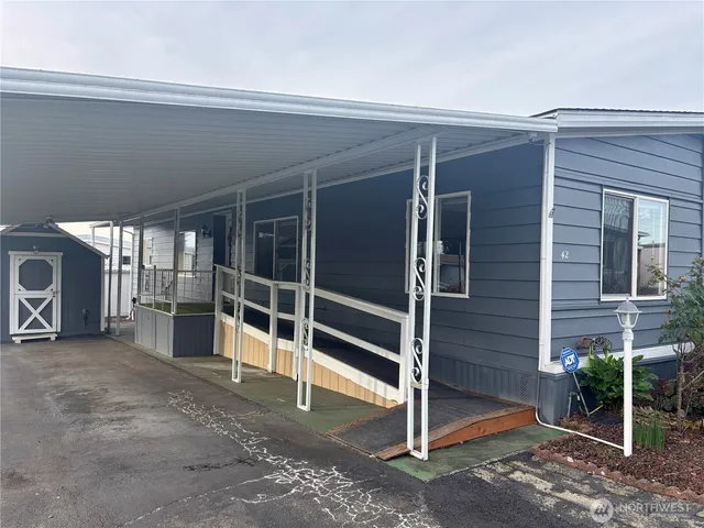 a view of a house with a door and wooden floor