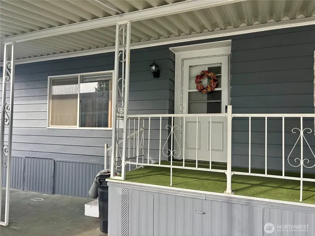 a view of a house with a window and wooden fence
