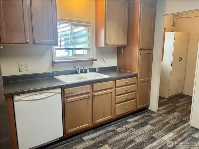 a kitchen with appliances cabinets and a sink
