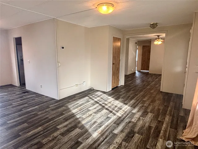 a view of an empty room and wooden floor