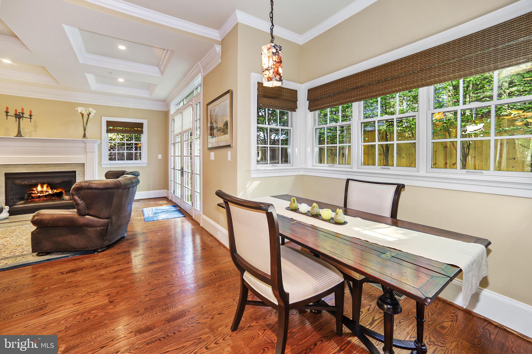 7117 Exfair Road Bethesda, MD 20814 - Photo 13 of 42 a view of a dining room with furniture window and wooden floor
