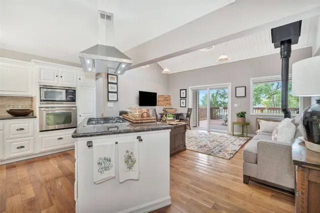 a view of cabinets a island and a stove in a room