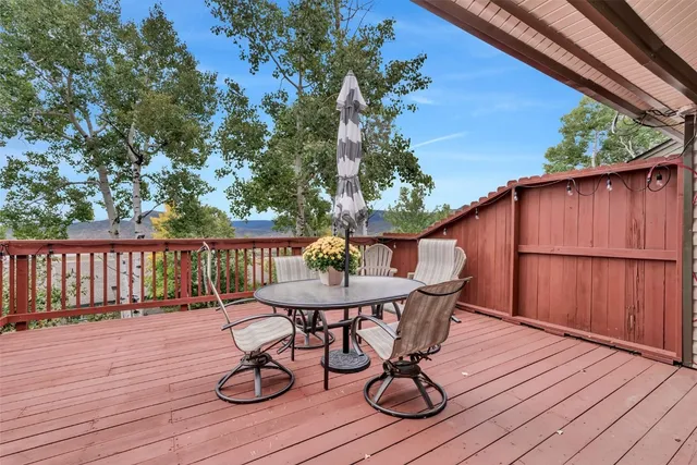 a balcony with wooden floor and fence