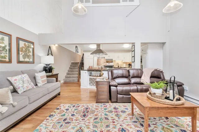a view of staircase with lots of frames on wall and a window