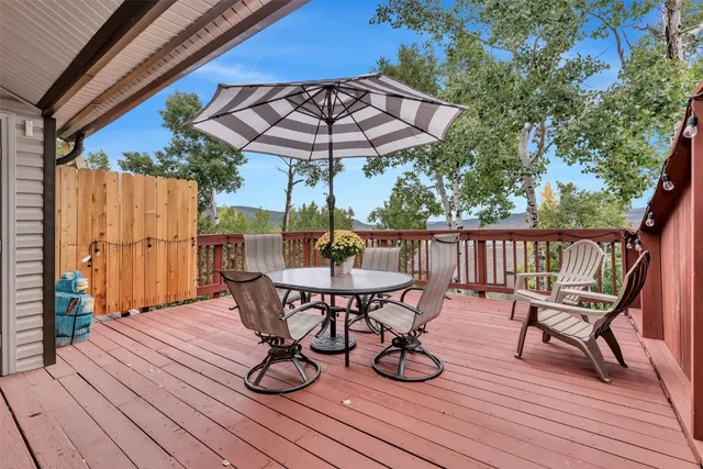 a view of a balcony with wooden floor and outdoor seating