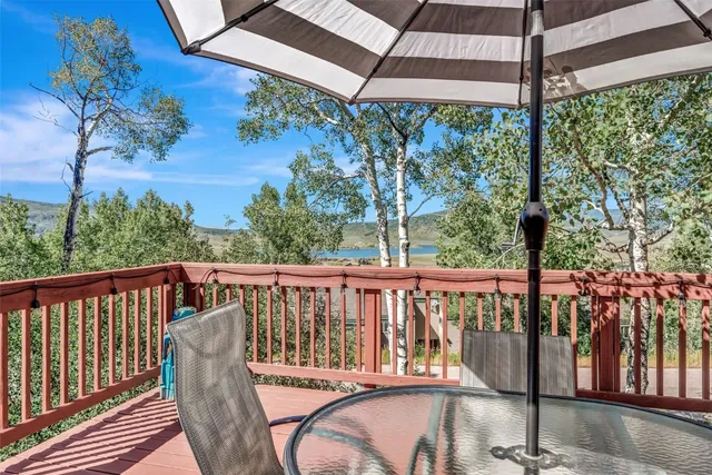 a view of a brick house with roof and deck