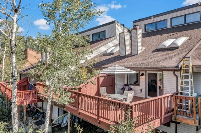 a view of a patio with table and chairs and wooden floor