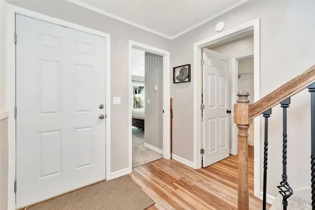 a view of a livingroom with wooden floor and entryway