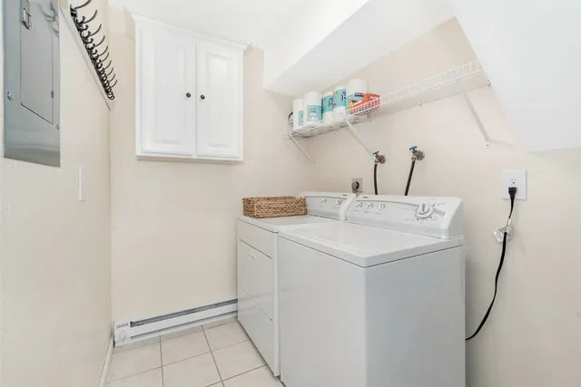 a utility room with cabinets washer and dryer