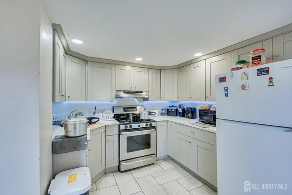 a kitchen with a white stove top oven and refrigerator