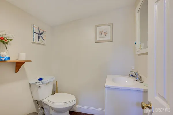 a white toilet sitting next to a bathroom sink