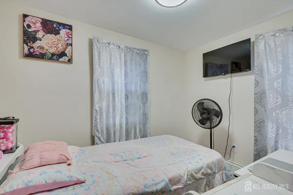 a bedroom with a bed and a television