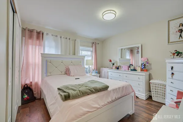 a bedroom with a bed and a dresser