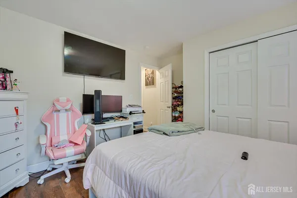 a bedroom with a bed and a flat screen tv