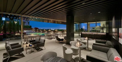 a outdoor living space with furniture and a grill