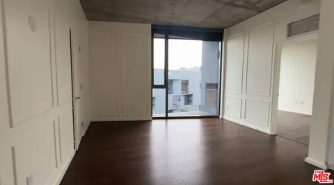 a view of wooden floor and windows in a room