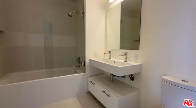 a bathroom with a sink bathtub and a toilet