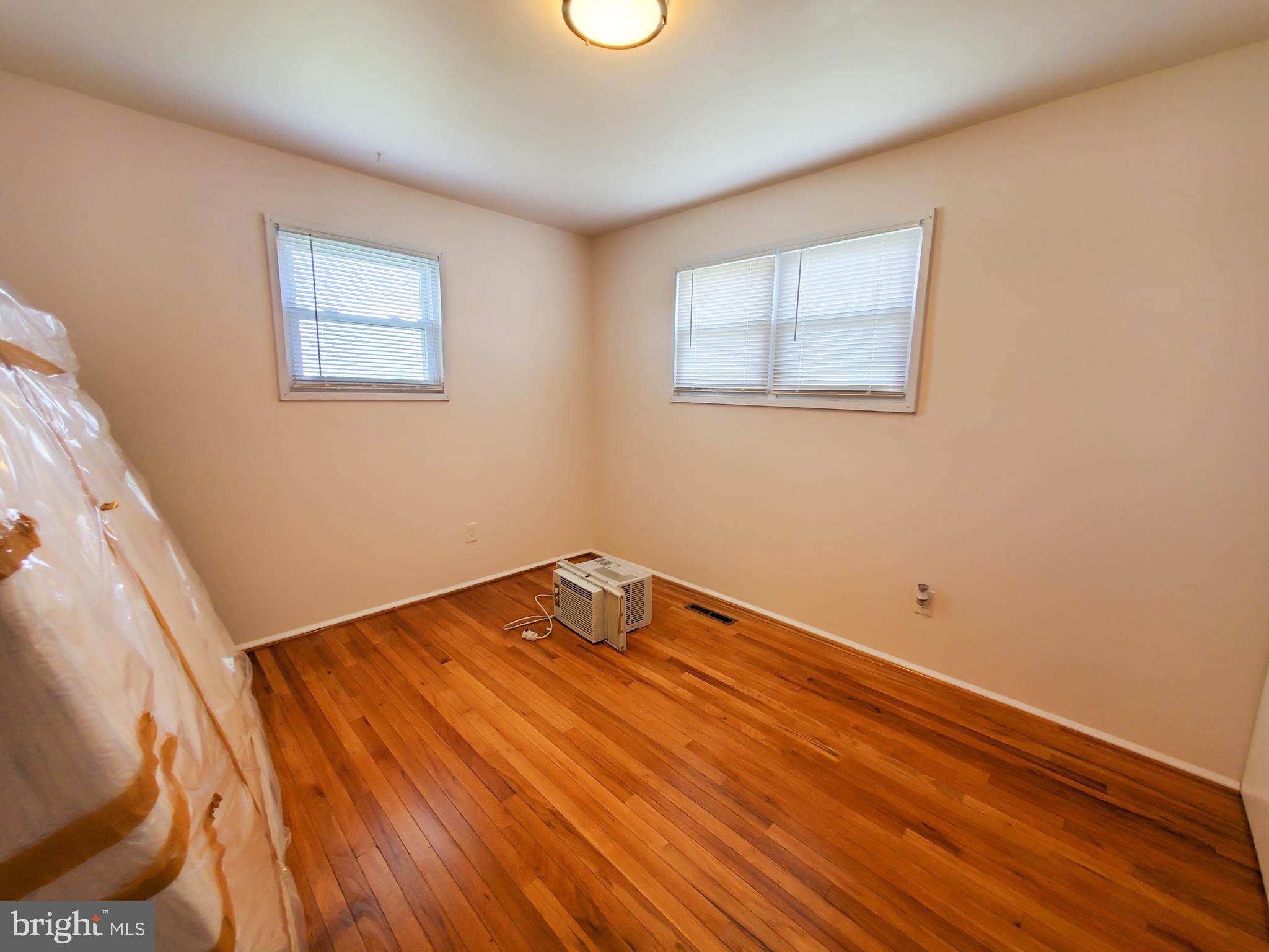 1512 Customs Road Baltimore, MD 21237 - Photo 16 of 43 a room with a bed and wooden floor
