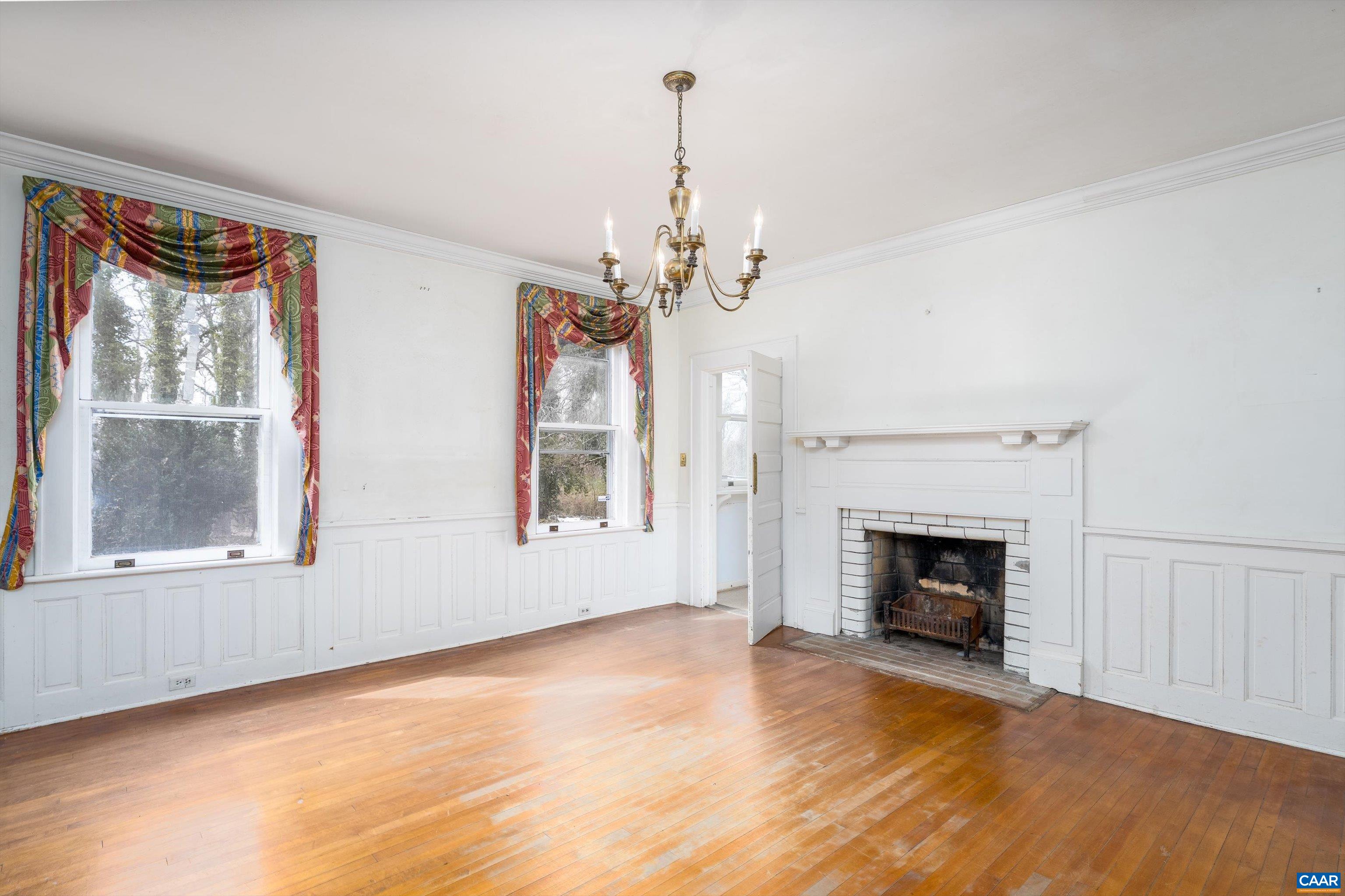 278 James River Road Scottsville, VA 24590 - Photo 11 of 59 a view of an empty room with a fireplace and a window