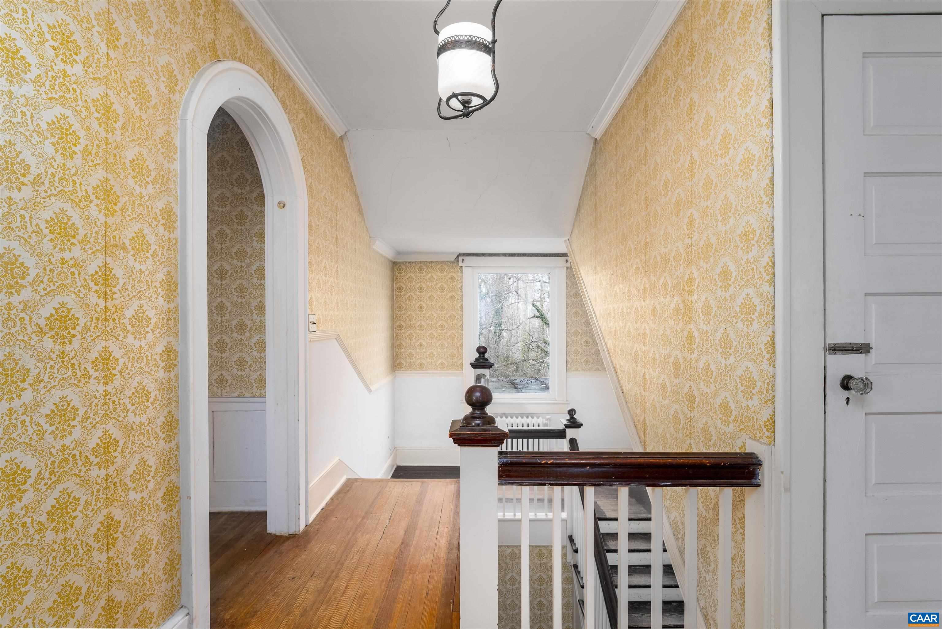 278 James River Road Scottsville, VA 24590 - Photo 25 of 59 a view of a hallway with wooden floor and staircase