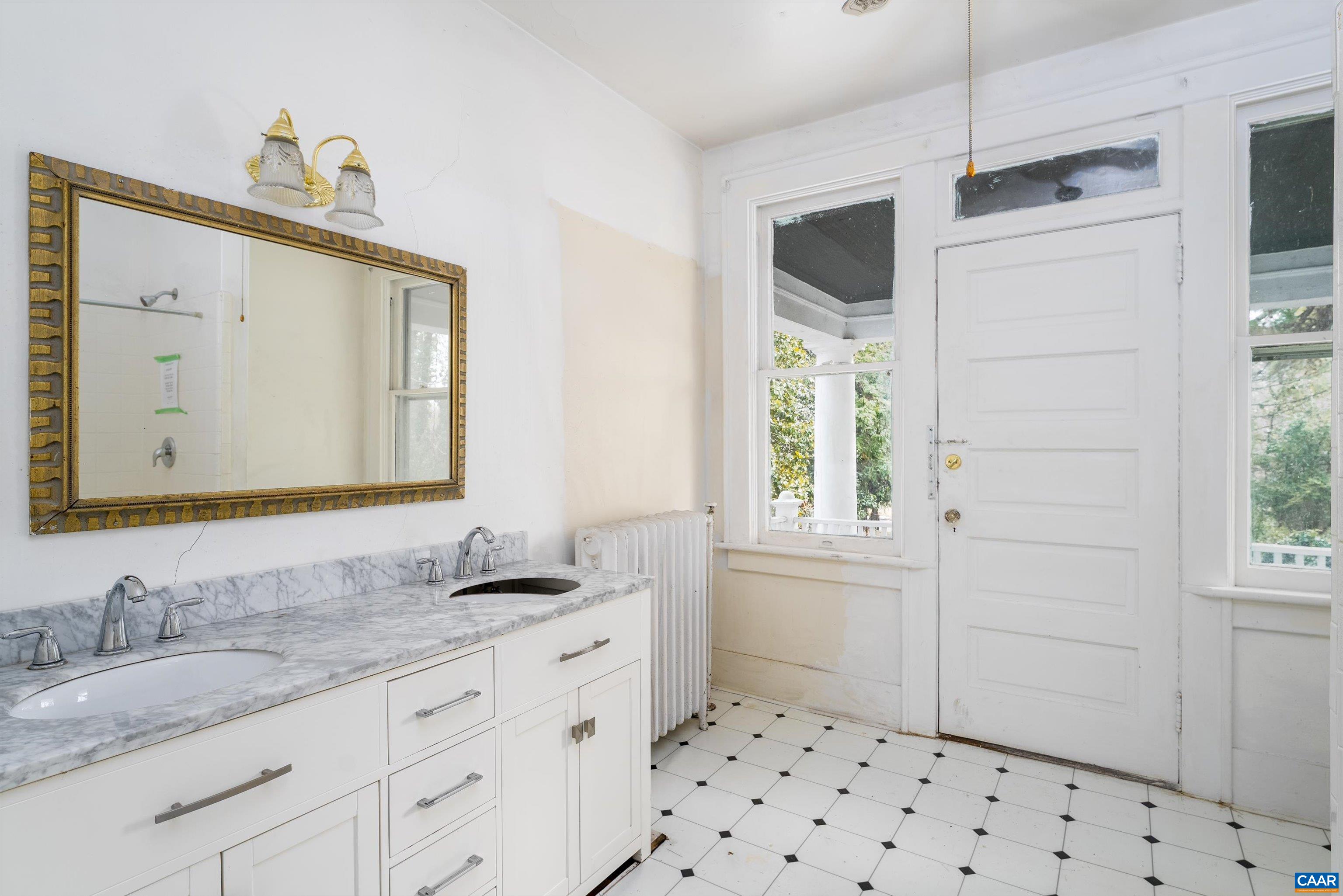 278 James River Road Scottsville, VA 24590 - Photo 27 of 59 a bathroom with a granite countertop sink a mirror and a shower