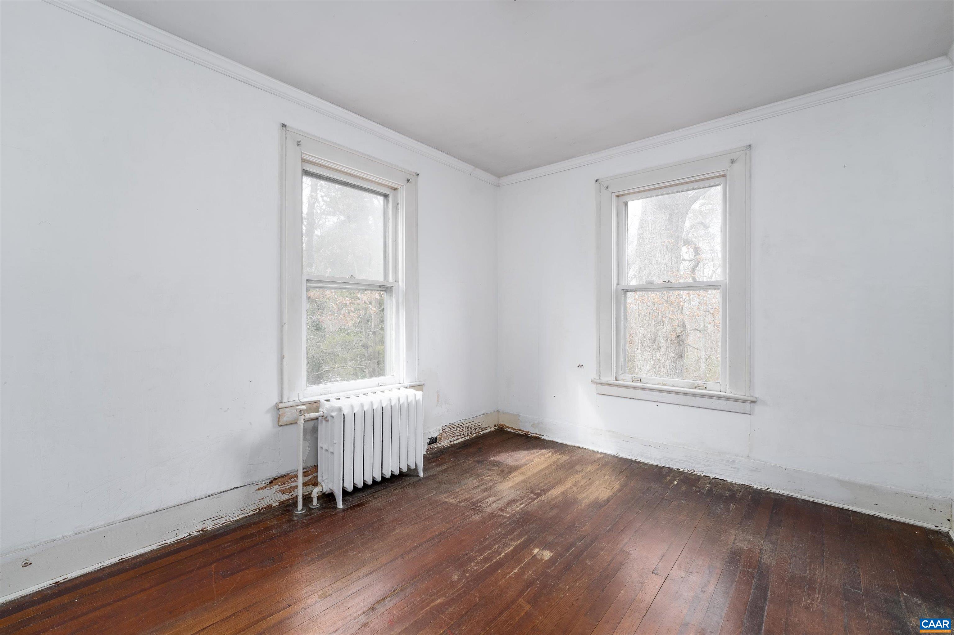 278 James River Road Scottsville, VA 24590 - Photo 36 of 59 an empty room with wooden floor and windows