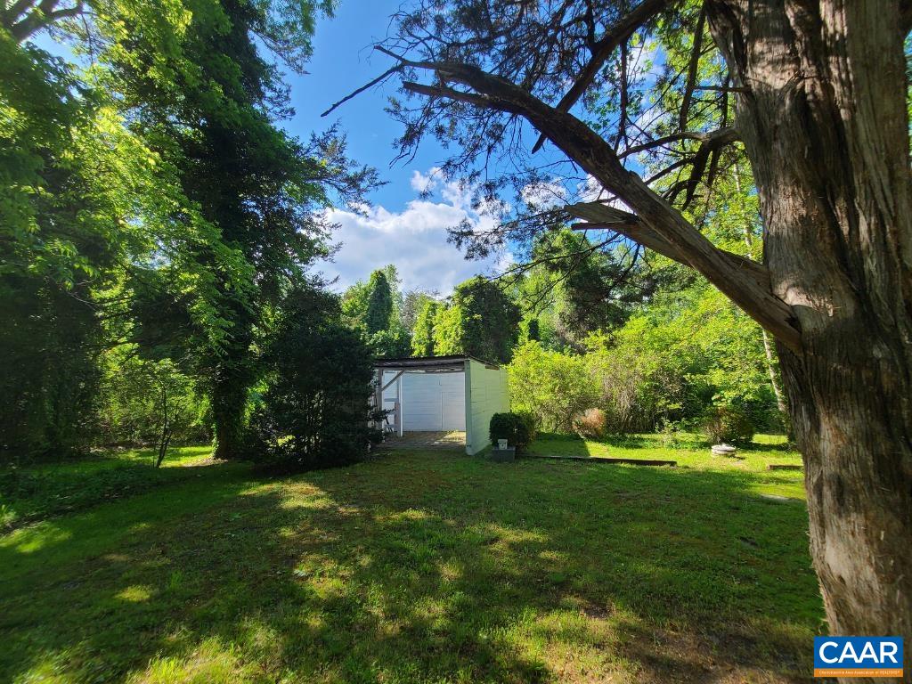 278 James River Road Scottsville, VA 24590 - Photo 43 of 59 a view of a white house with a big yard and large trees