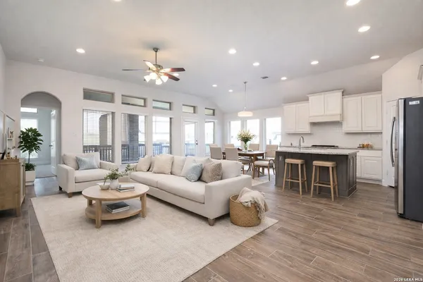 a living room with furniture kitchen and a table