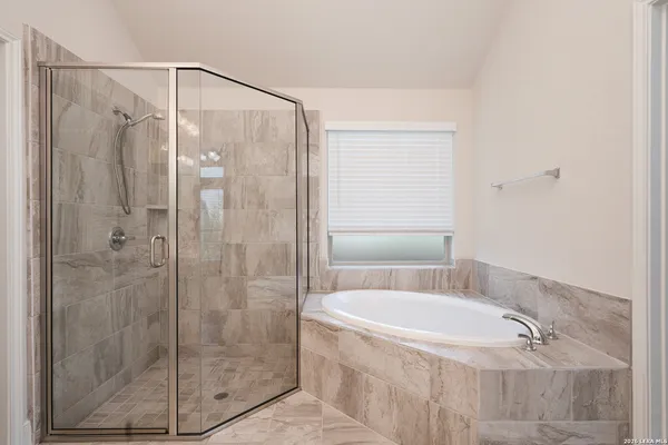 a bathroom with a shower and a bathtub