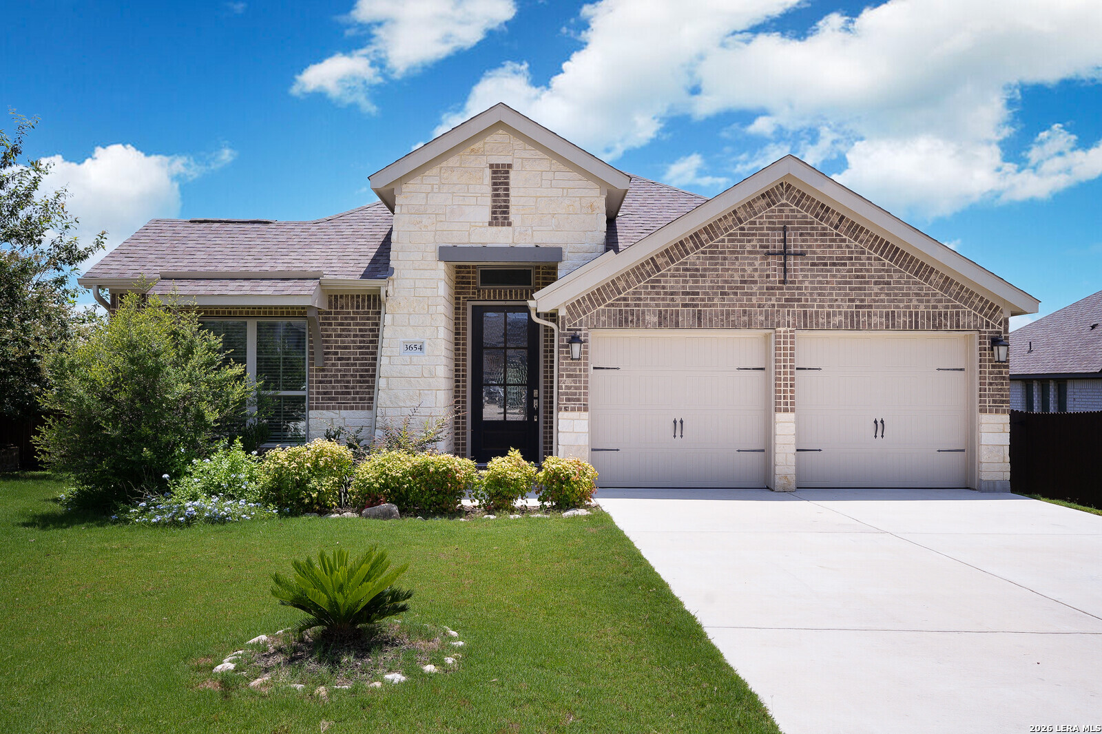 3654 Braford Way Bulverde, TX 78163 - Photo 2 of 32 a front view of a house with a yard and garage
