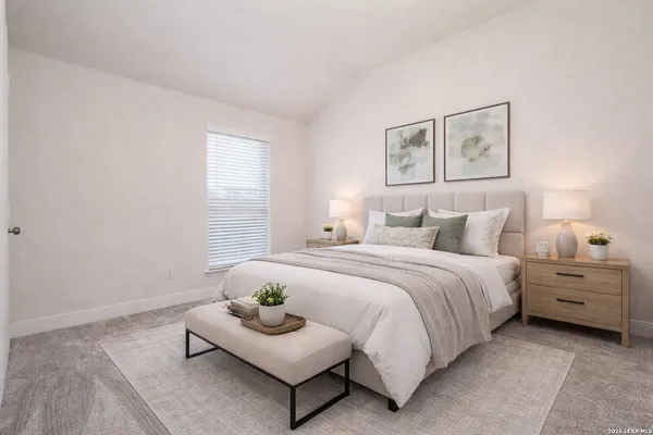 a spacious bedroom with a bed and window
