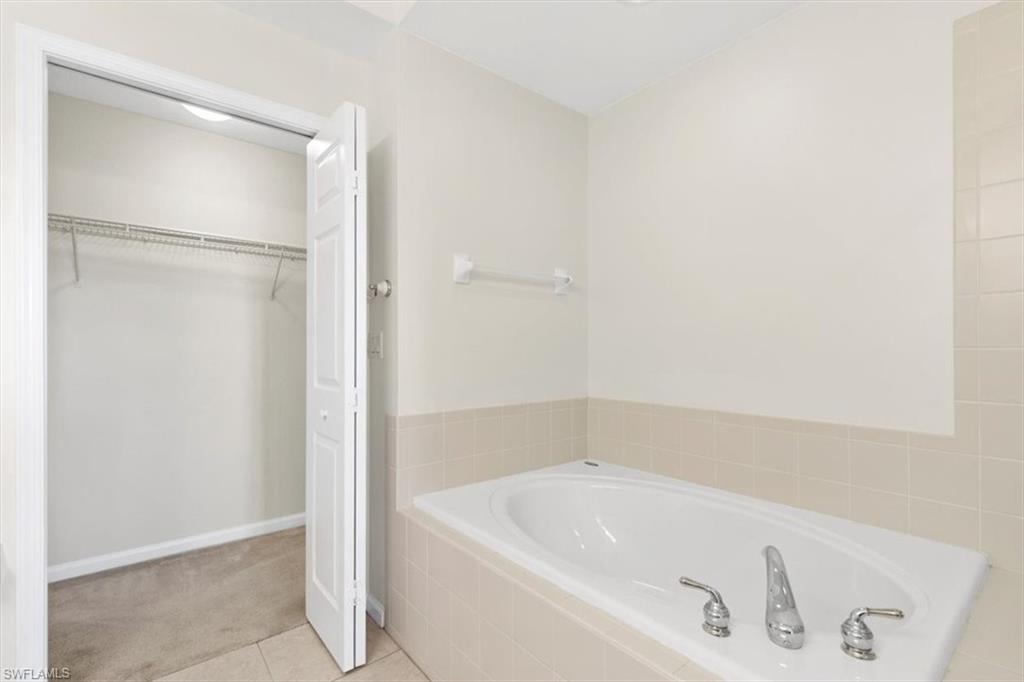 7092 Timberland Circle, Unit 1101 Naples, FL 34109 - Photo 20 of 48 a bathroom with a bathtub