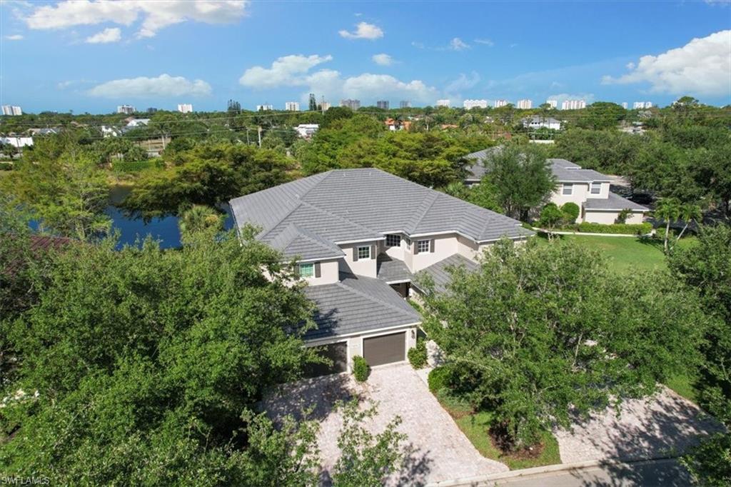 7092 Timberland Circle, Unit 1101 Naples, FL 34109 - Photo 2 of 48 an aerial view of residential houses with outdoor space and street view