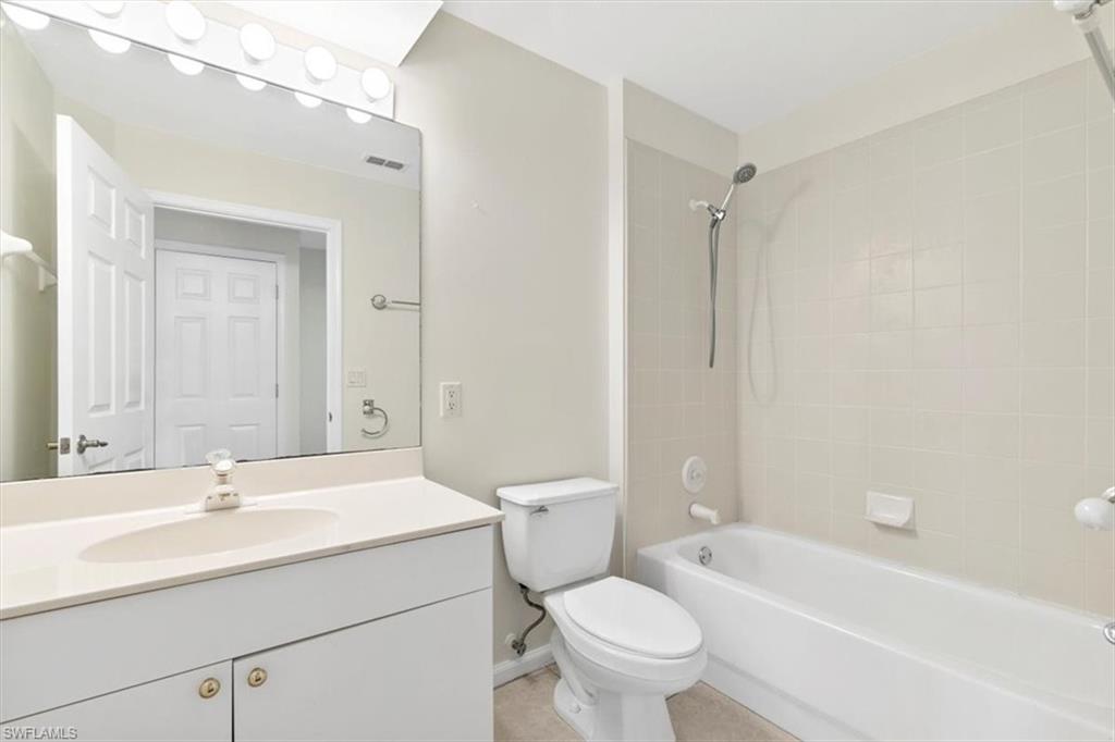 7092 Timberland Circle, Unit 1101 Naples, FL 34109 - Photo 23 of 48 a bathroom with a sink toilet vanity and shower