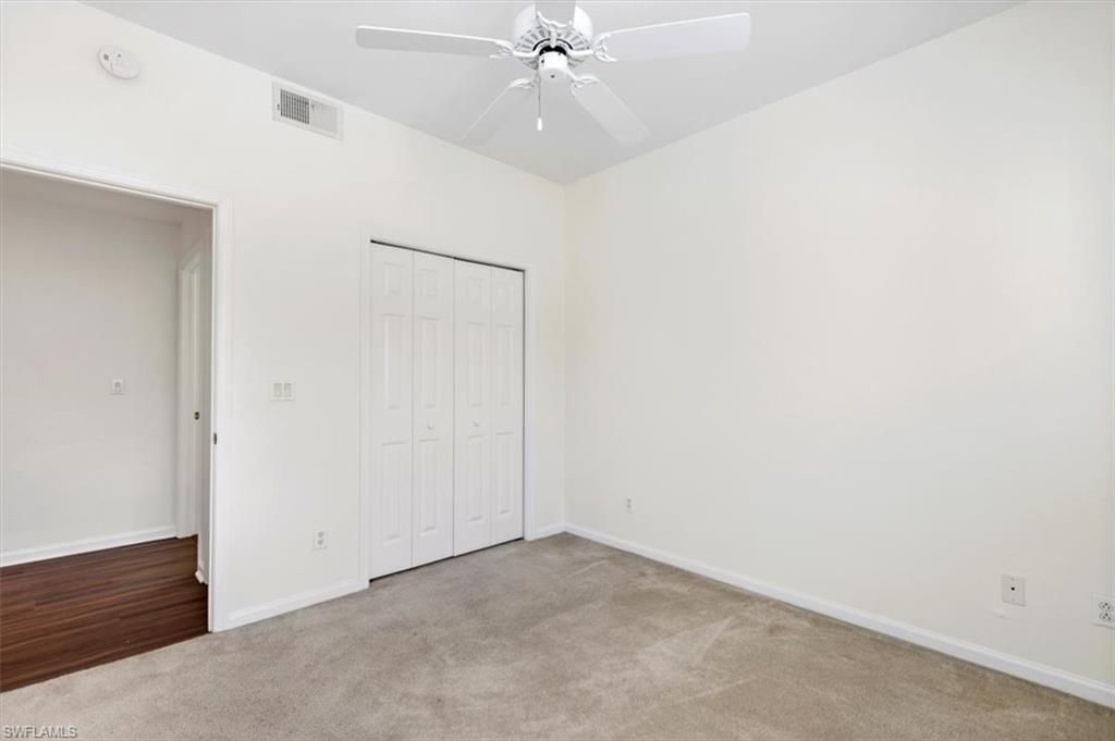 7092 Timberland Circle, Unit 1101 Naples, FL 34109 - Photo 25 of 48 an empty room with a ceiling fan and a window
