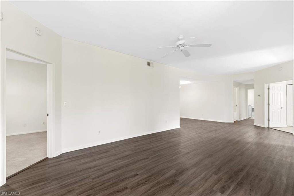 7092 Timberland Circle, Unit 1101 Naples, FL 34109 - Photo 3 of 48 an empty room with wooden floor and windows