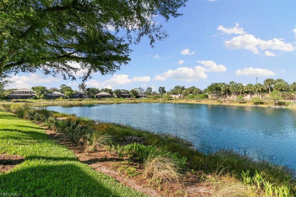 7092 Timberland Circle, Unit 1101 Naples, FL 34109 - Photo 35 of 48 a view of a lake with houses in the back