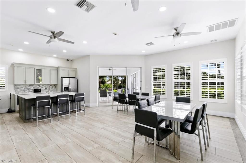 7092 Timberland Circle, Unit 1101 Naples, FL 34109 - Photo 40 of 48 a view of a dining room with furniture window and wooden floor