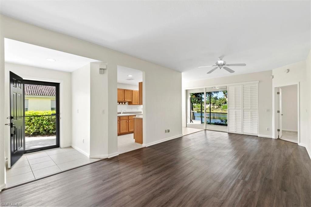 7092 Timberland Circle, Unit 1101 Naples, FL 34109 - Photo 4 of 48 a view of an empty room with window and wooden floor