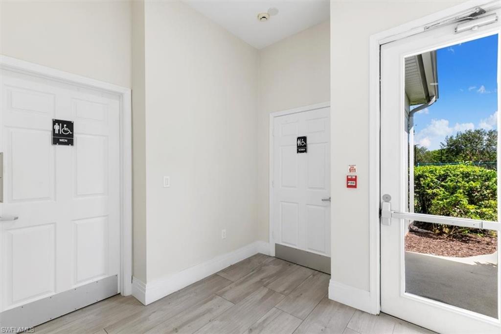 7092 Timberland Circle, Unit 1101 Naples, FL 34109 - Photo 42 of 48 an entryway and a hallway with wooden floor