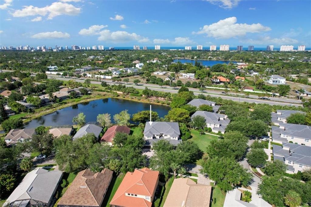7092 Timberland Circle, Unit 1101 Naples, FL 34109 - Photo 46 of 48 an aerial view of residential houses with outdoor space and trees