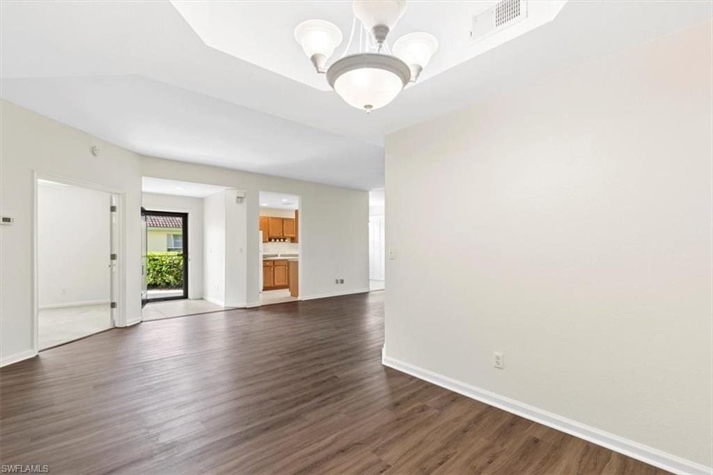 7092 Timberland Circle, Unit 1101 Naples, FL 34109 - Photo 8 of 48 a view of an empty room with wooden floor