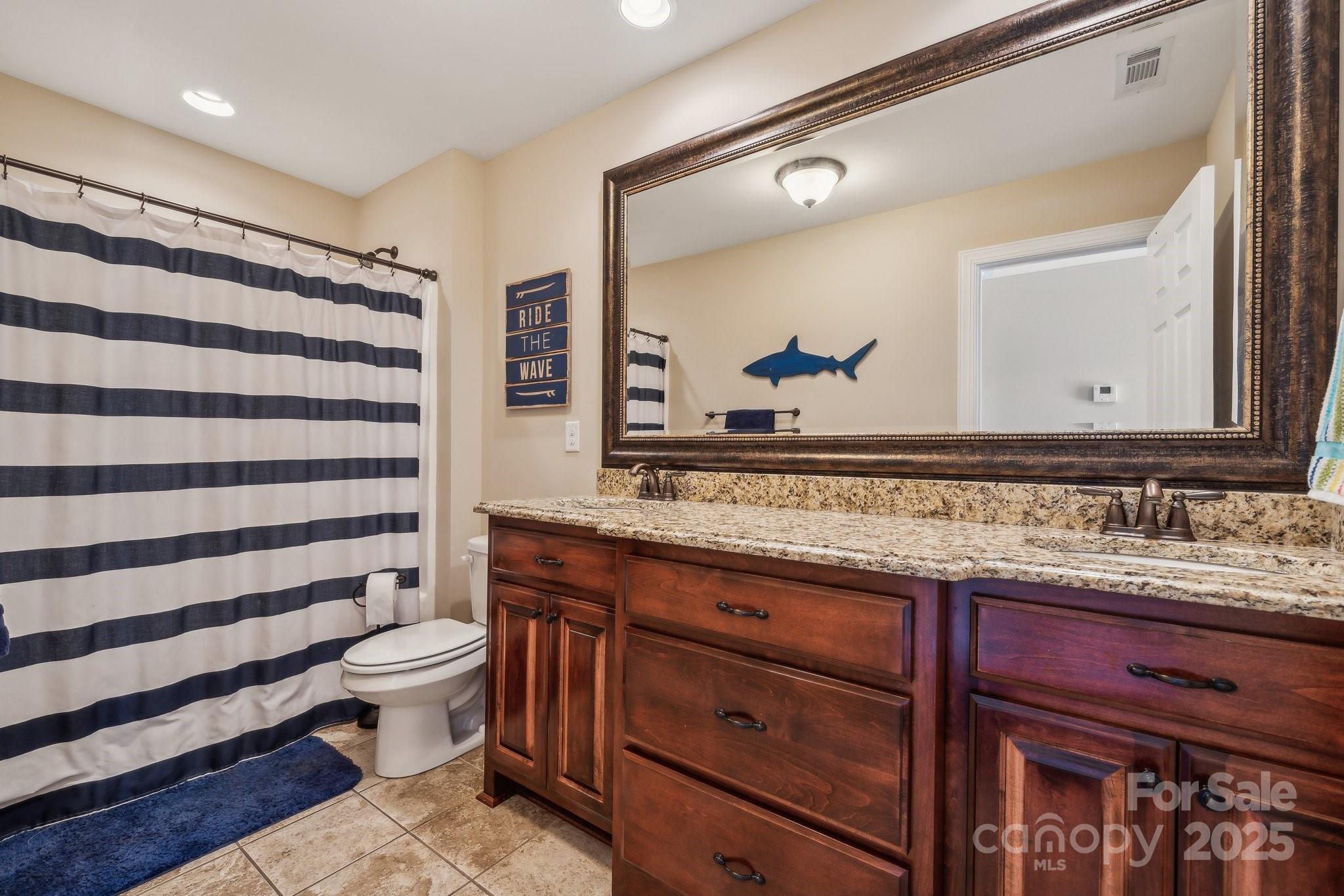 4006 Sincerity Road Monroe, NC 28110 - Photo 20 of 36 a bathroom with a sink a toilet and a mirror