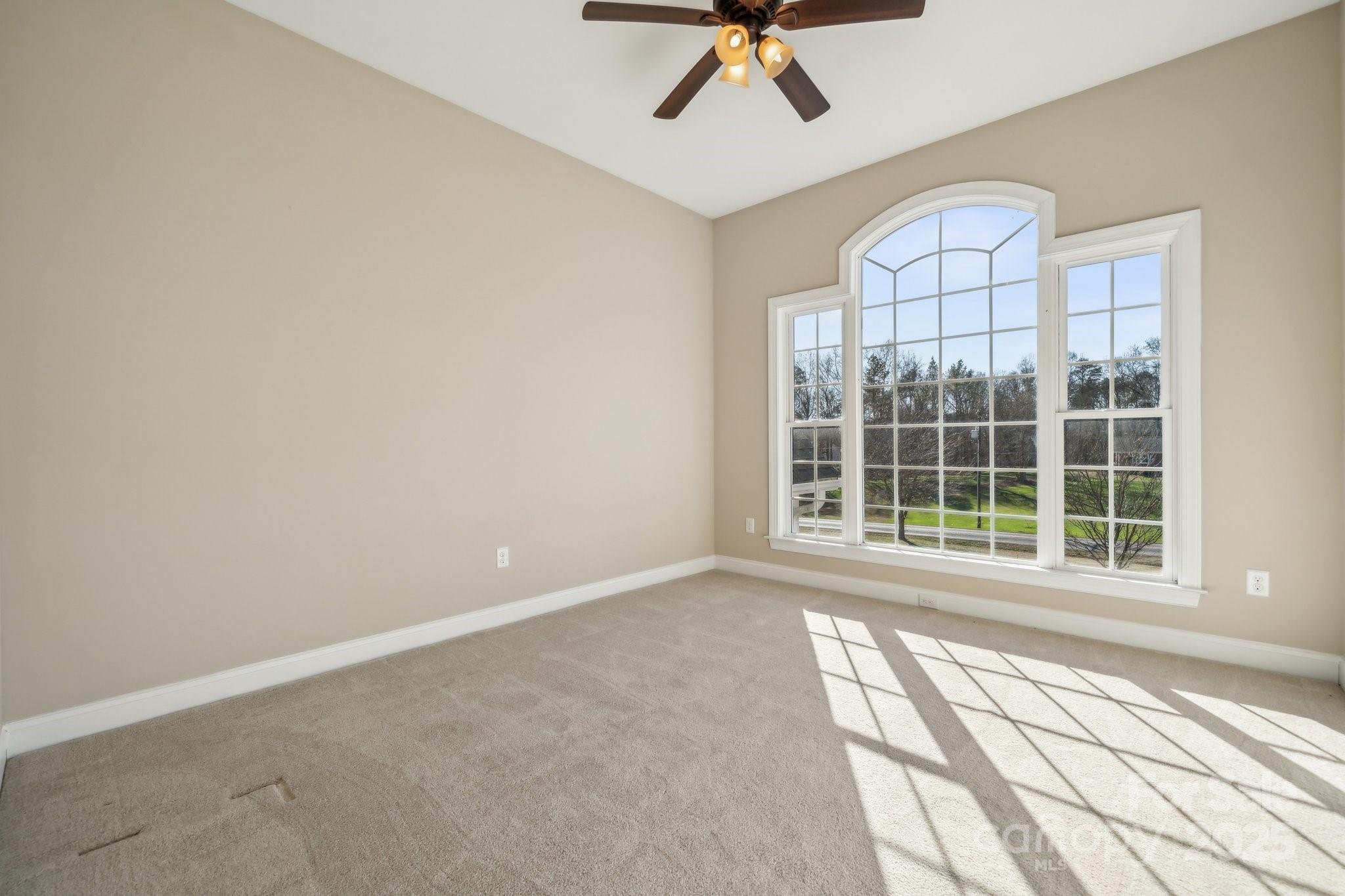 4006 Sincerity Road Monroe, NC 28110 - Photo 23 of 36 an empty room with windows and fan