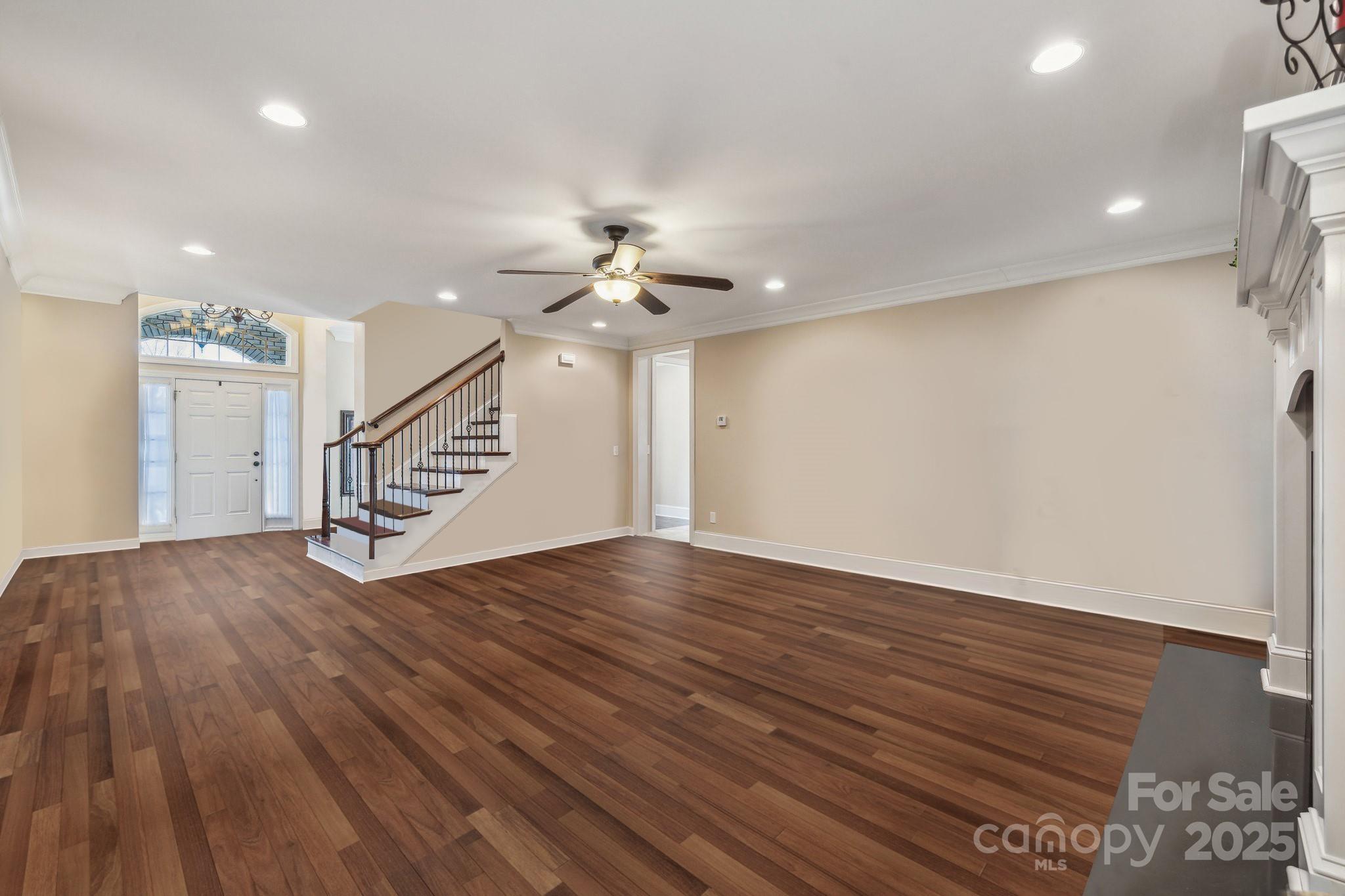4006 Sincerity Road Monroe, NC 28110 - Photo 5 of 36 a view of an empty room with wooden floor and stairs