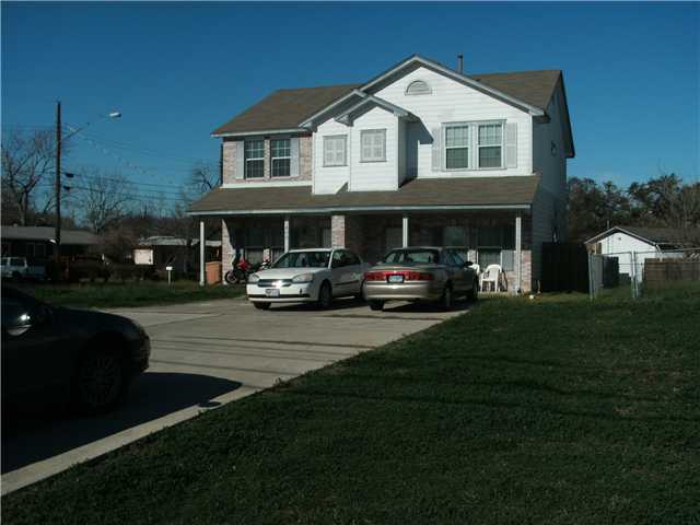 1800 Springdale Road Austin, TX 78721 - Photo 1 of 1 a front view of a house with a garden and yard