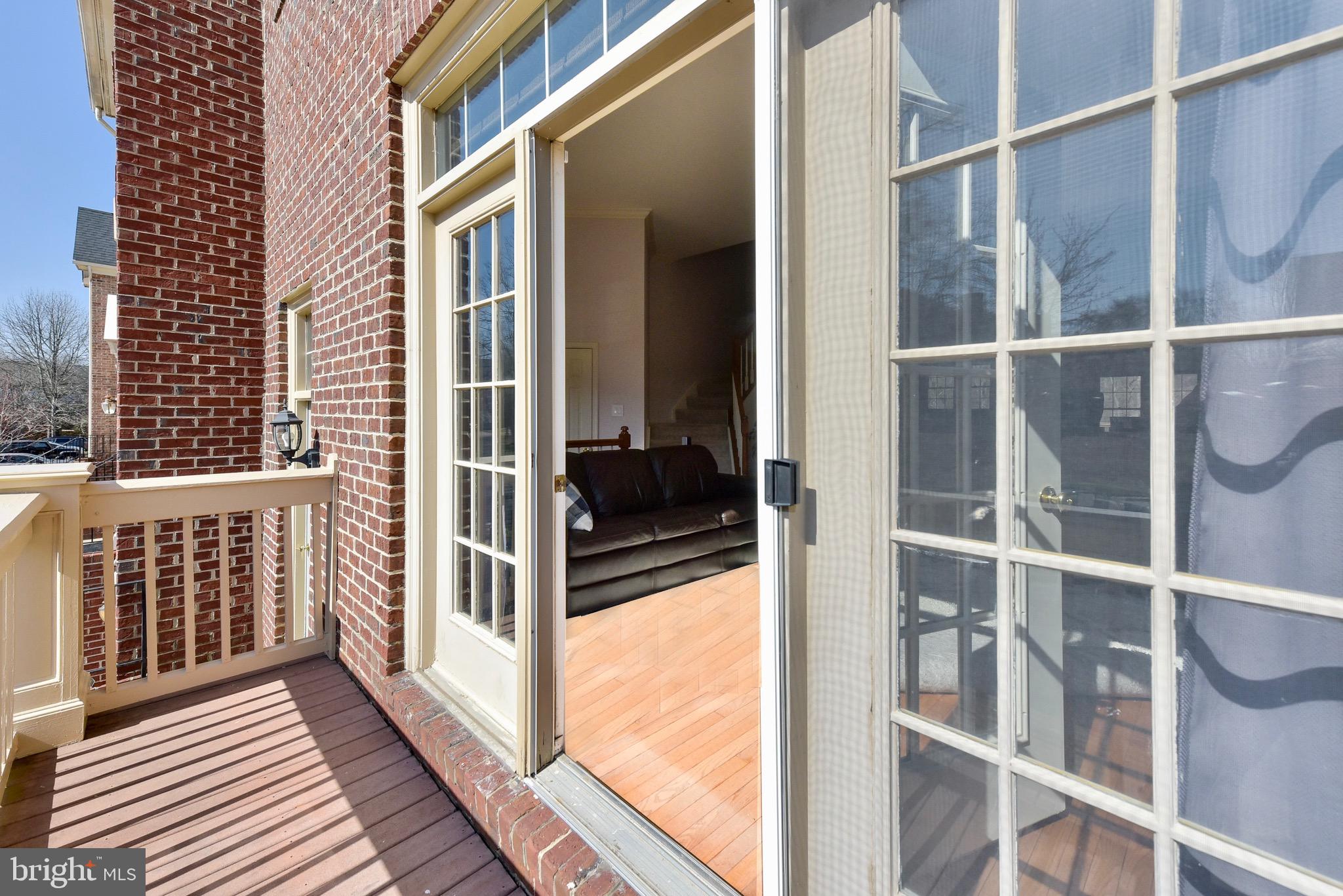 20320 Burnley Square Sterling, VA 20165 - Photo 5 of 37 Step out onto the balcony off the living room.